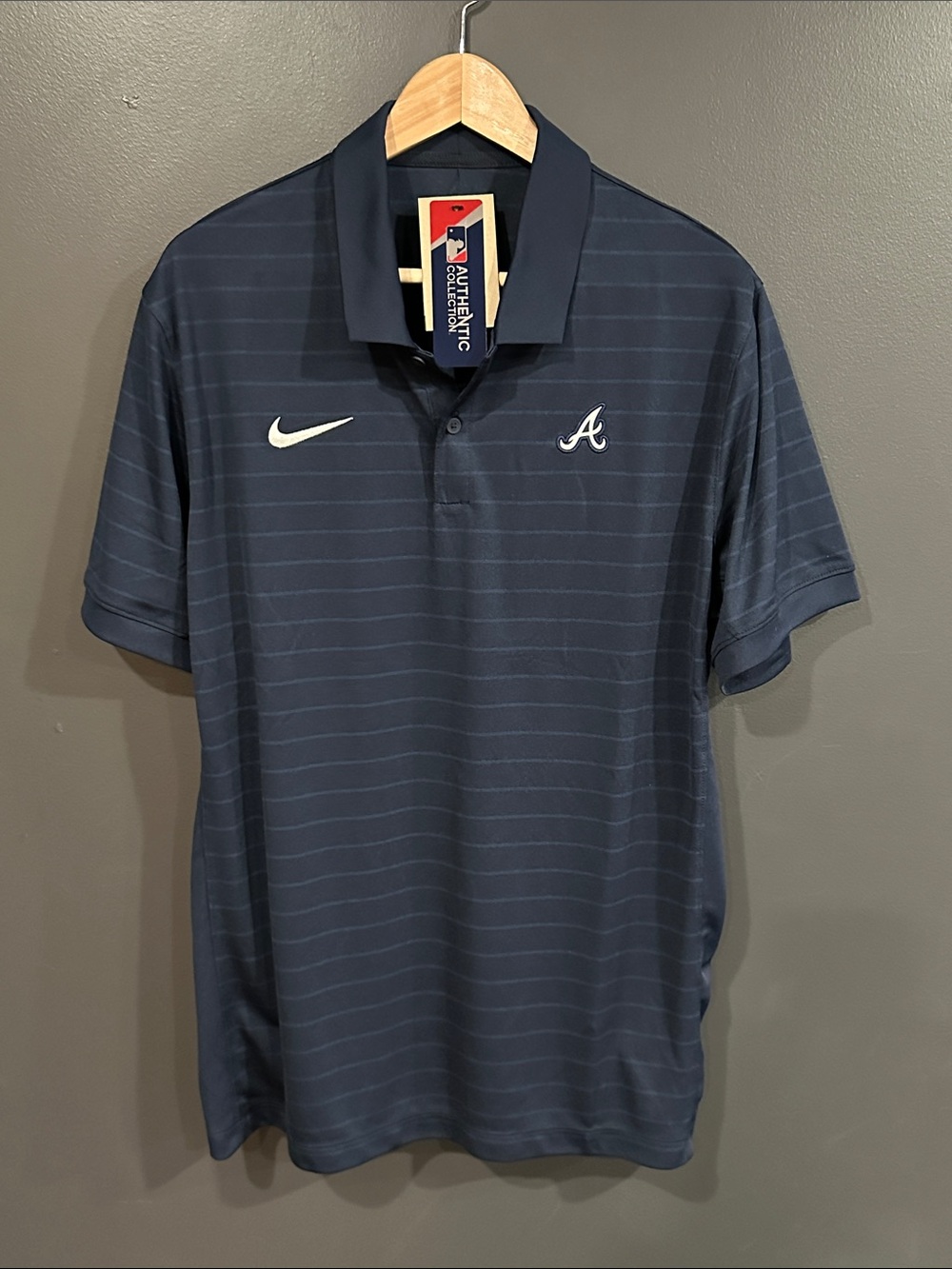 Nike Men's Navy Polo with White Swoosh and Emblem